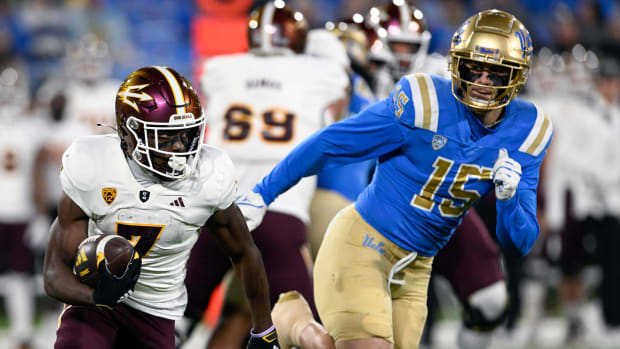 Nov 11, 2023; Pasadena, California, USA; Arizona State Sun Devils wide receiver Melquan Stovall (7) runs against UCLA Bruins defensive lineman Laiatu Latu (15) at the Rose Bowl. Mandatory Credit: Alex Gallardo-USA TODAY Sports  